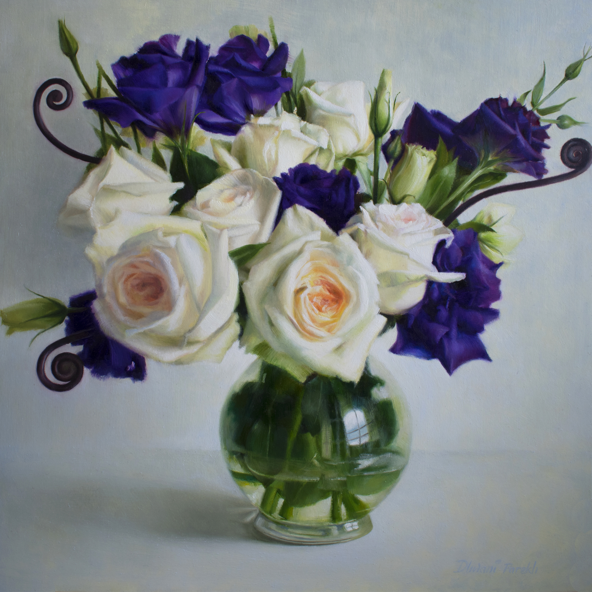 White roses and purple lisianthus in a glass vase